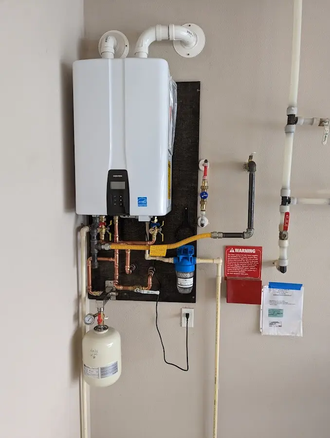 Professional plumber installing copper piping in a Elm Creek home